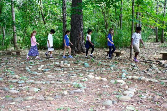 WOODED LABYRINTH The stone labyrinth is a quiet space for students to walk and reflect. Sometimes used for class discussion to bring focus to a learning concept, the permanent spiral of painted rocks created by previous generations of students is revered by current students and campers.